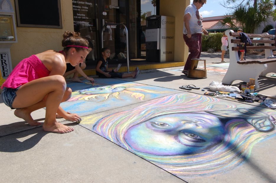 Artists creating pavement art at the Venice International Chalk Festival Florida